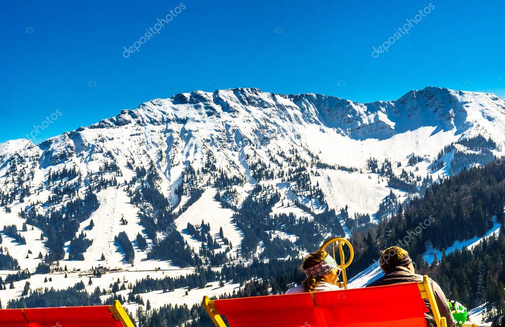 View on people enjoying snowy mountain landscape in the bavarian alps - Germany
