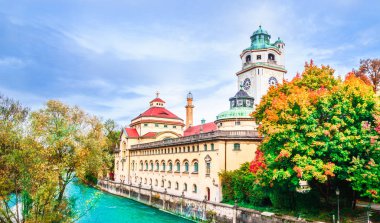 View on Colorful autumn landscape in front of Mueller Volksbad of Isar river - Munich clipart