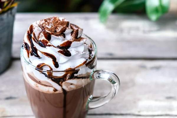 Hot chocolate cocoa in glass mug with whipped cream — Stock Photo, Image