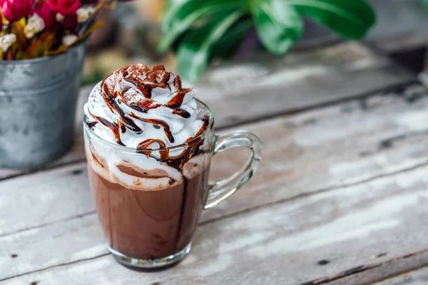 Hot chocolate cocoa in glass mug with whipped cream — Stock Photo, Image