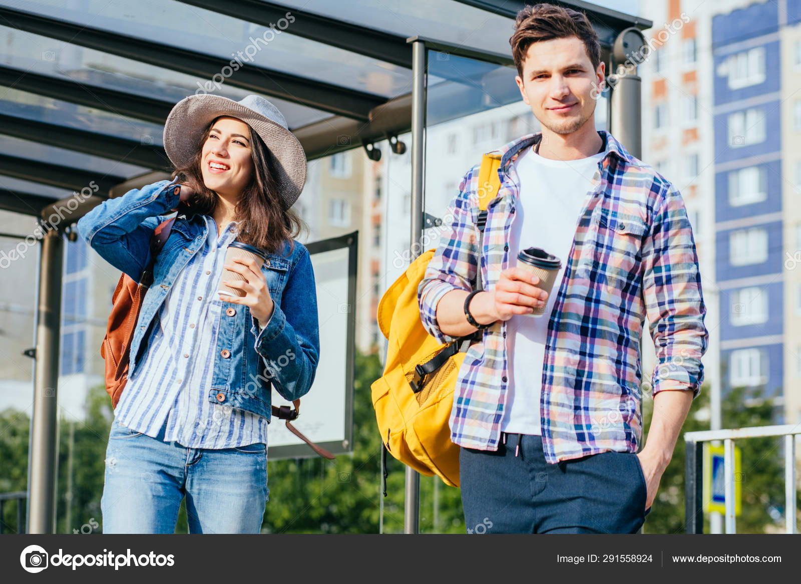 Guy At Bus Stop Looking At Girl Standing Next To Him Waiting For