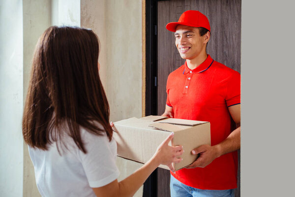 friendly young african american delivery man delivering a package
