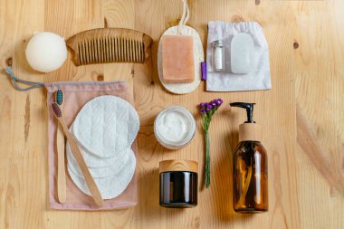 Sıfır atık banyo aksesuarı, ahşap tarak, deodorant, sünger, Shea yağı, katı sabun ve şampuan çubukları, yeniden kullanılabilir pamuk temizleme pedleri, cam bir kapta makyaj temizleyicisi..