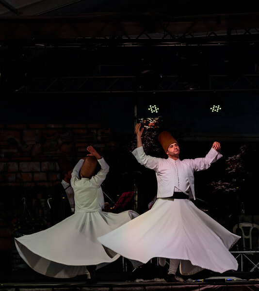 The Turkish whirling dancers or Sufi whirling dancers performing of the Mevlevi (whirling dervish) sema  at the festival LO SPIRITO DEL PIANETA