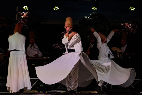 The Turkish whirling dancers or Sufi whirling dancers performing of the Mevlevi (whirling dervish) sema  at the festival LO SPIRITO DEL PIANETA