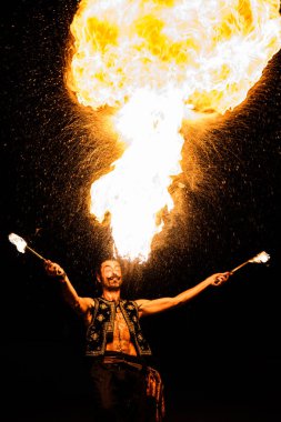 Bergamo, Italy - August 26, 2018: Italian fire-eater perform at Pollo Metal Fest at Spazio Polaresco (BG). Brambilla Simone Live News photographer clipart