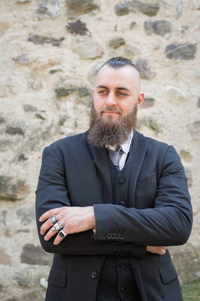 Man Long Beard Wears Dark Elegant Suit Posing Front Stone — Stock Photo, Image