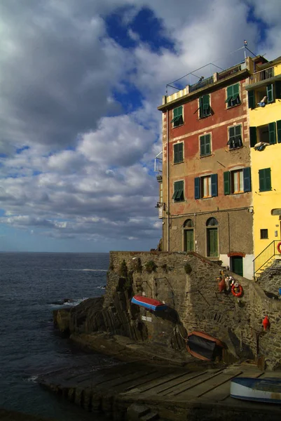 Village of Riomaggiore, rocks and sea covered by clouds. Cinque — Stock Photo, Image