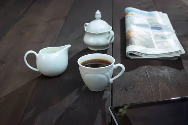 Braun Wooden Table Cap Saucer Spoon Newspaper Sugar Bowl Jug — Stock Photo, Image