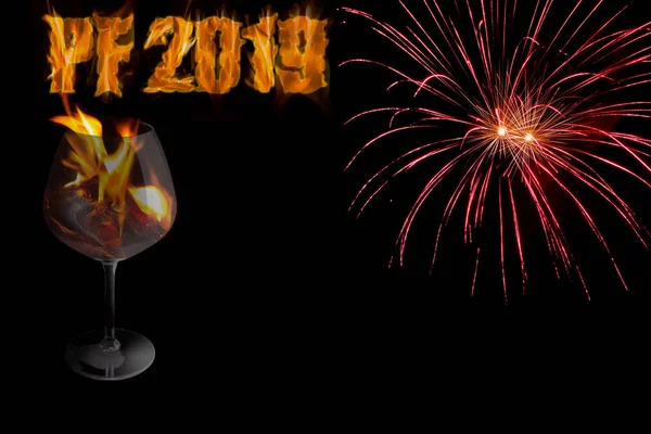 PF 2019 - happy New Year with a glass in a fire and red fireworks on black background with free space for text.