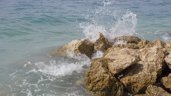 Surf waves of the sea in Croatia. Waves lap against the rocks and sprayed.