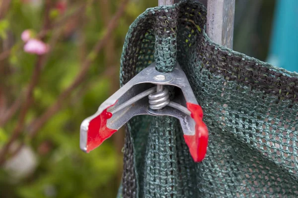 stock image Detail of metal clamp holding garden canvas