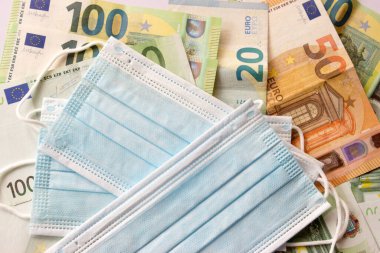 Masks are placed on euro banknotes business money  clipart
