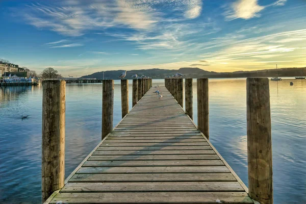 A jetty on a calm Windermere at sunset. — Stock Photo, Image