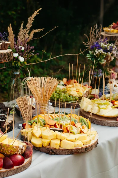 Beautiful wedding candy bar with a lot of  sweets, fruits and food. Wedding banquet table