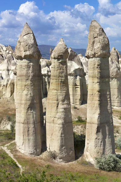 Rural landscape in the Valley of Love, Cappadocia. Large phallic rock formations against the blue summer sky.