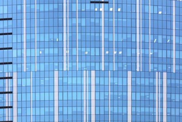 The facade of the glass building of blue glass. Horizontal and vertical lines in the facade of modern buildings