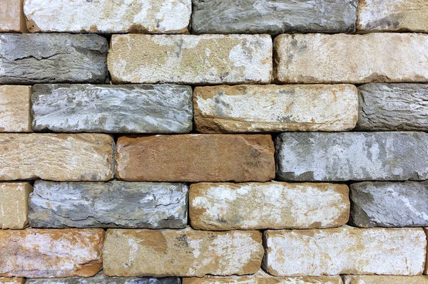 A textura da parede de pedra do tijolo velho, pedra de construção de arenito . — Fotografia de Stock