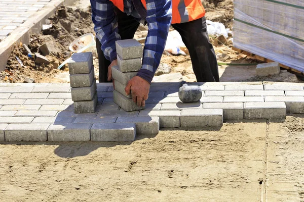 Trabajador trae losas de pavimentación para ponerlo en la acera . —  Fotos de Stock