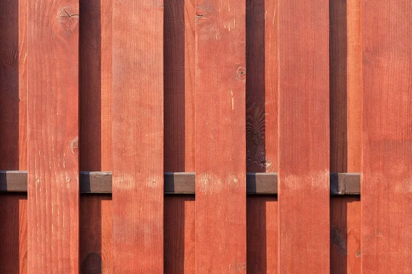 Textuur van een houten hek met een nieuwe verticale bruine achtergrond — Stockfoto