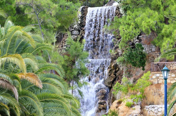 Большой водопад с радоновой водой среди валунов у подножия горы в Лутраки, Греция . — стоковое фото