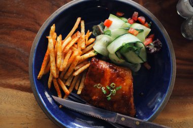 ızgara domuz pirzola biftek bir restoranda eski rustik ahşap üzerinde taze sebze ile