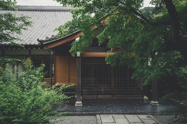 Japanese temple with japanese maple tree leaves in Kyoto vintage film style