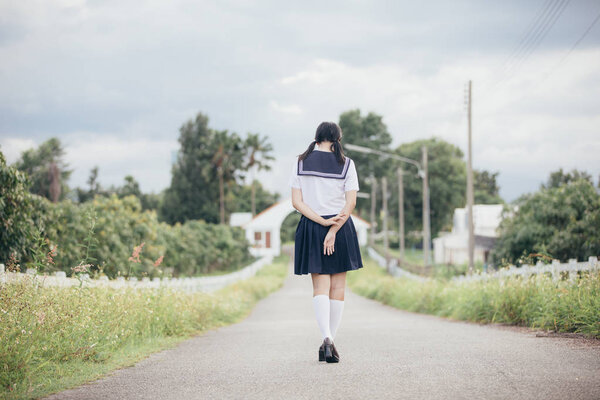 Portrait of asian japanese school girl costume looking at park outdoor film vintage style