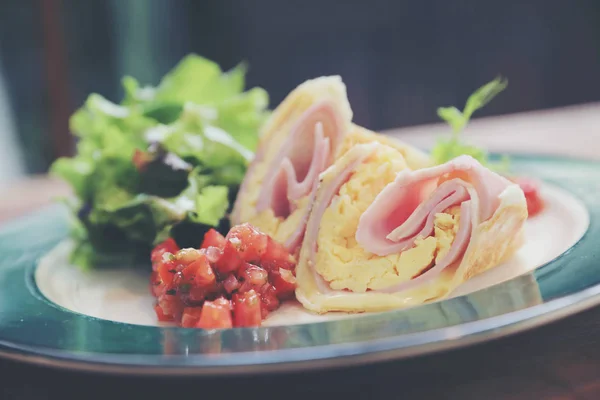 Breakfast burrito ham and eggs with salad vintage style