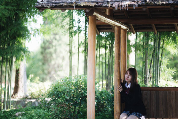 Portrait of asian japanese school girl costume looking at park outdoor film vintage style