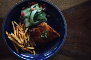 ızgara domuz pirzola biftek bir restoranda eski rustik ahşap üzerinde taze sebze ile