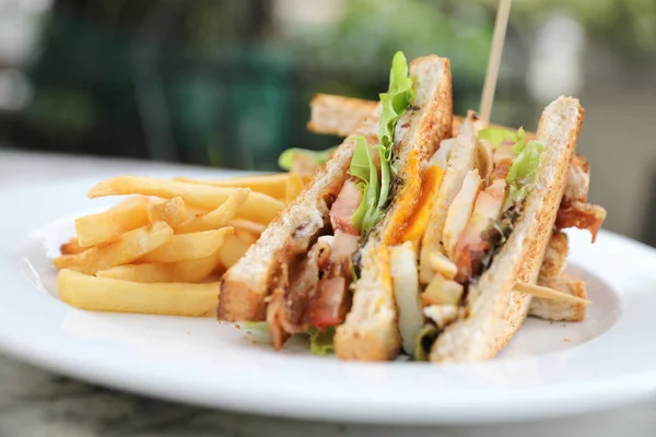 Club sandwich , Sandwich with egg bacon chicken tomato with fried outdoor restaurant background