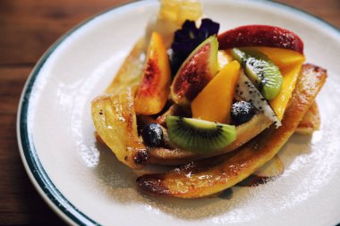 Tatlı Waffle meyve kivi muz üzüm berry ve vanilyalı dondurma vintage tarzı ile pişmiş.