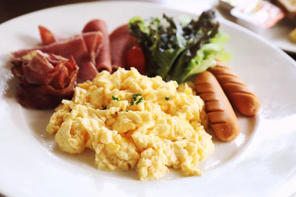 早餐炒鸡蛋与培根香肠和沙拉在木背景 — 图库照片