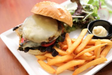 Sığır eti Hamburger patates kızartması ve salata ahşap arka plan üzerinde