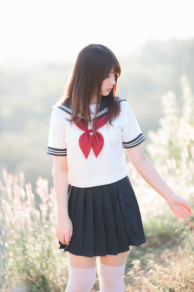 Portrait of asian japanese school girl costume looking at park o