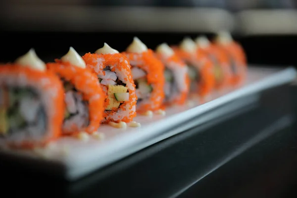 Sushi con rollo de california, rollo de arroz con huevo de aguacate y pescado —  Fotos de Stock