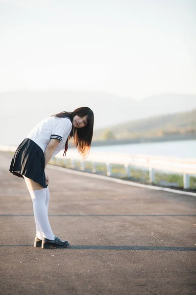 Ritratto di ragazza della scuola giapponese sorriso uniforme con passerella e — Foto Stock