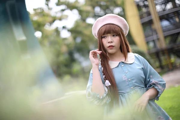 Portrait of asian girl in lolita fashion dress in garden — Stock Photo, Image