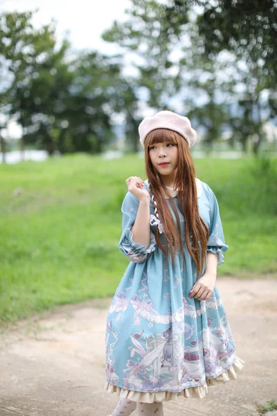 Portrait of asian girl in lolita fashion dress in garden — Stock Photo, Image