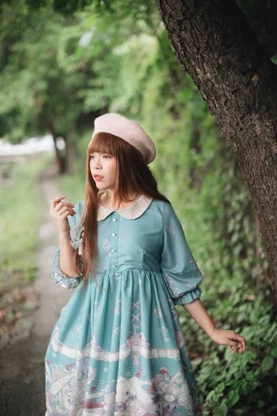 Portrait of asian girl in lolita fashion dress in garden — Stock Photo, Image