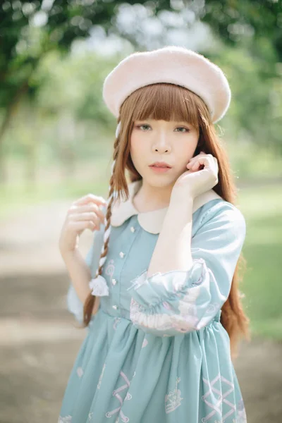 Portrait of asian girl in lolita fashion dress in garden backgro — Stock Photo, Image