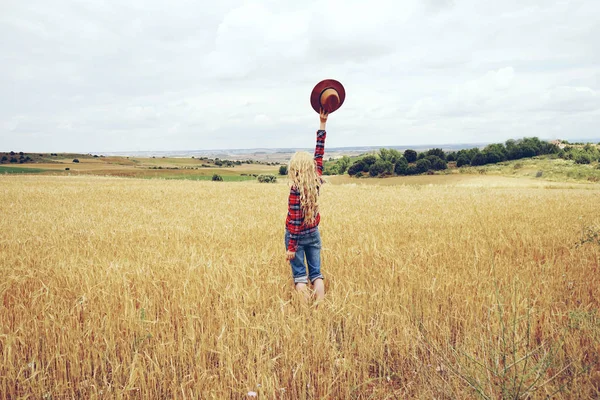 Back View Blonde Woman Holding Hat Standing Yellow Field Wheat — Stok Foto