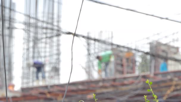 建筑工人在一个城市里建造一座居民楼的模糊镜头 — 图库视频影像