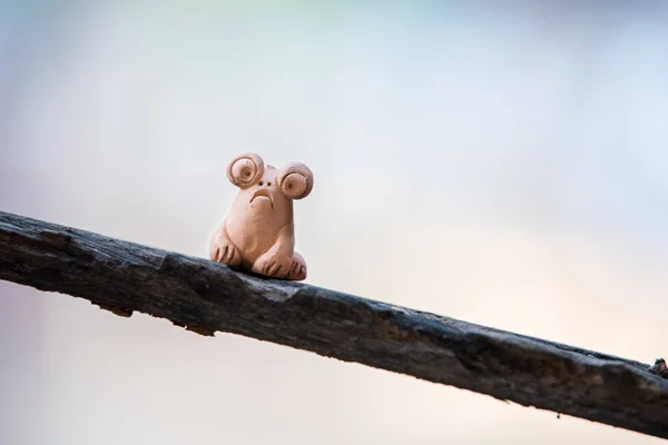 Clay doll frog on wood. — Stock Photo, Image