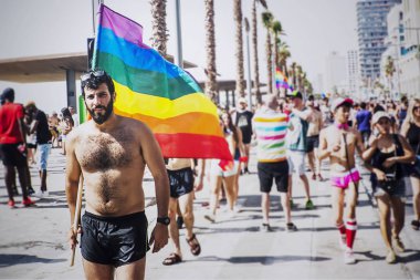 Tel Aviv, İsrail - 08 Haziran 2018: Katılımcılar, Eşcinsel gurur geçit Tel Aviv, İsrail - plaj boyunca yürüyüş ve gökkuşağı bayrağı tutan adam sokaklarında
