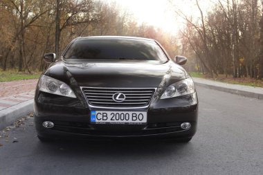 Kiev, Ukraine - November 5, 2018: Lexus ES car on the road against the backdrop of the forest clipart