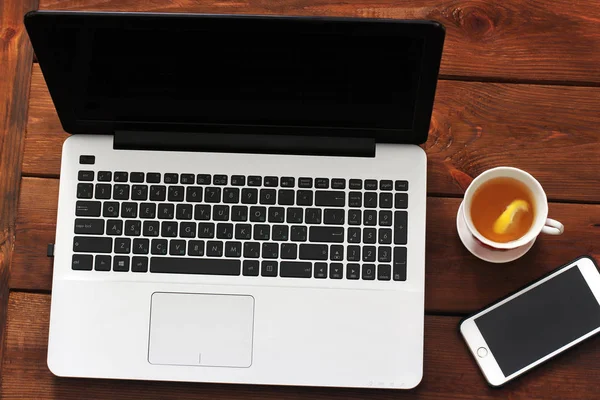 Laptop Phone And Tea On Wooden Background Stock Images Page Everypixel