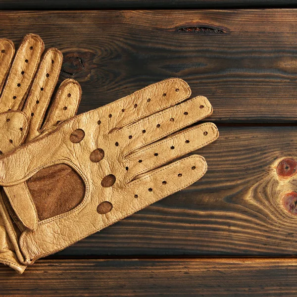 Leather gloves on a wooden background
