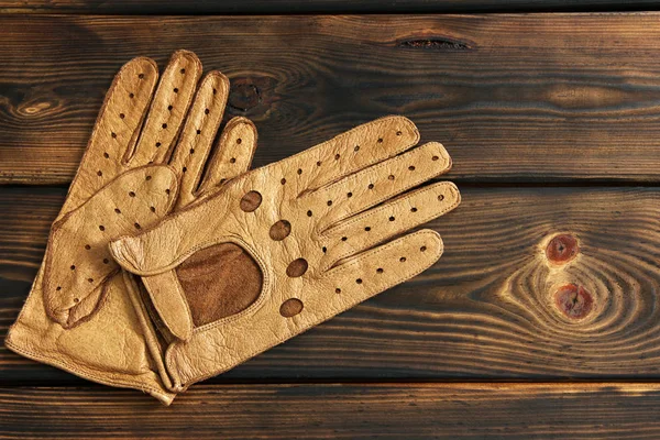 Leather gloves on a wooden background